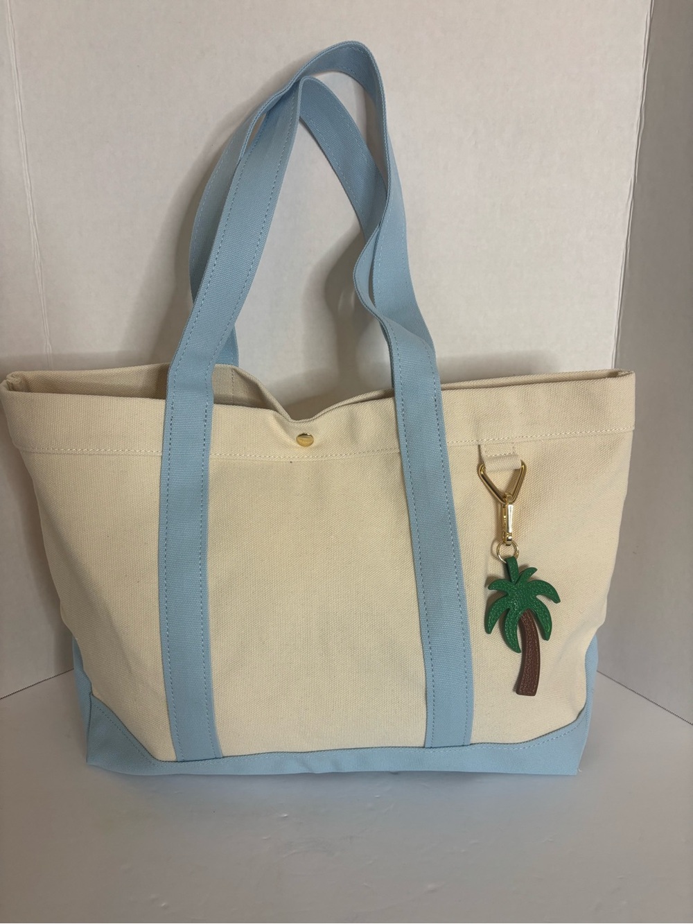 BaubleBar Cream Canvas Tote with Light Blue Straps and Palm Charm